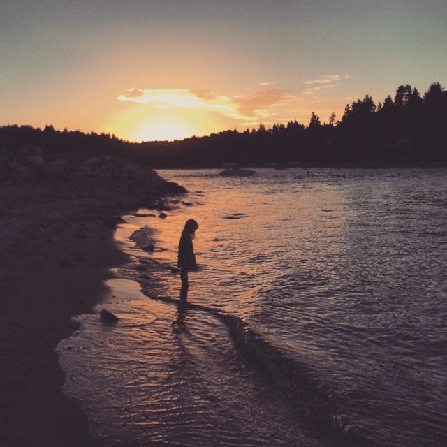 little girl in the waves at sunset_lake life