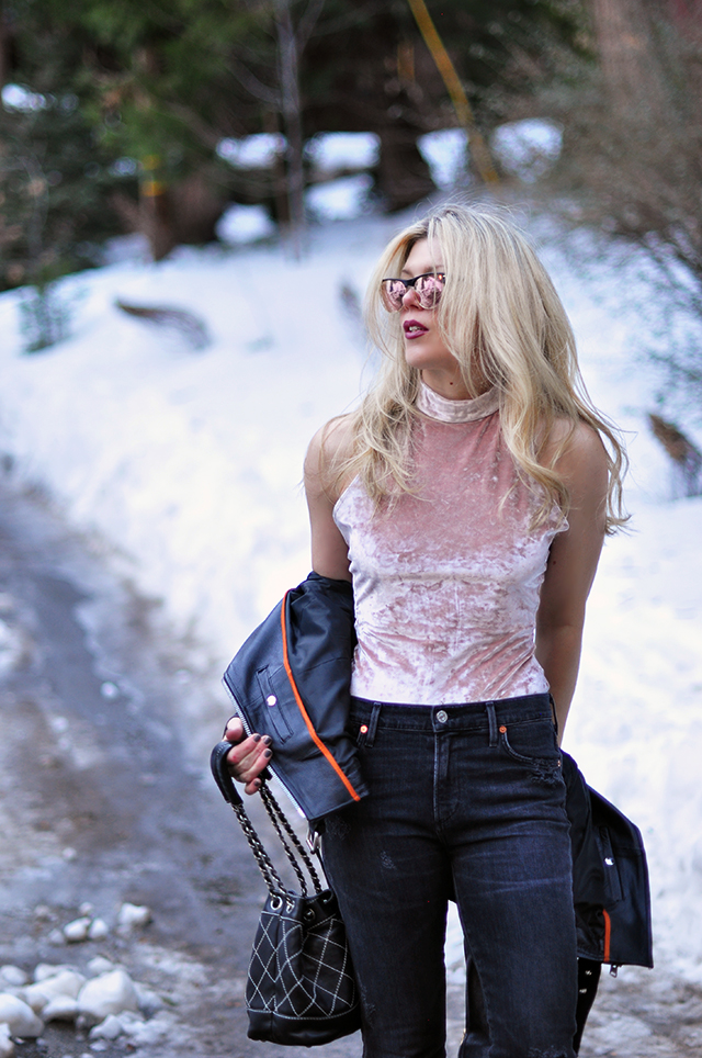 pink crushed velvet bodysuit, distressed denim, biker jacket, in the snow