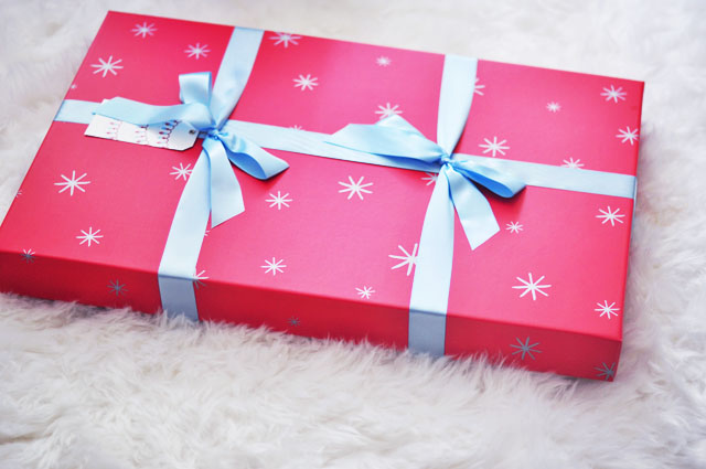 red holiday box with blue ribbon